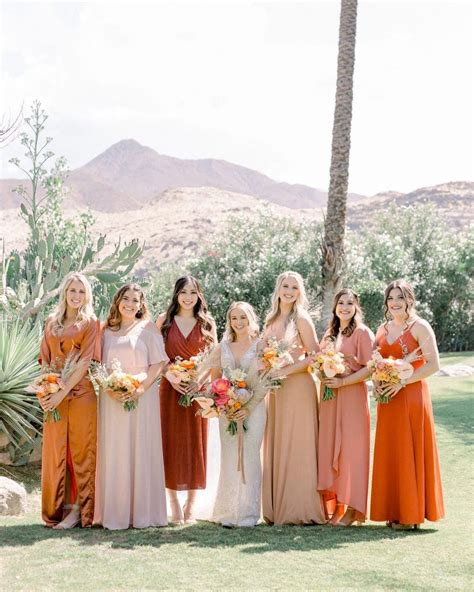 desert wedding featuring rust orange and peach colored mismatched bridesmaids dresses brid