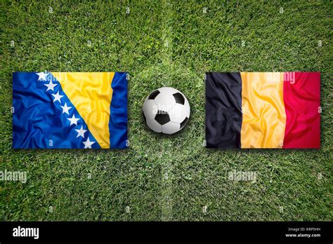 Bosnia And Herzegovina Vs Belgium Flags On Soccer Field Stock Photo