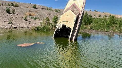Once Sunken Boat Now Partially Underwater Again At Lake Mead After