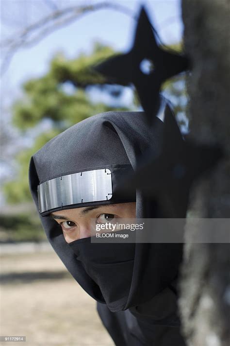 Ninja Hiding Himself Behind Tree High Res Stock Photo Getty Images