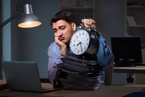 The Young Employee Working Overtime To Meet Deadline Stock Photo