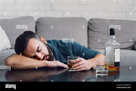 Alcohol Addiction Drunk Man Sleeping Leaning On Table With Bottle And