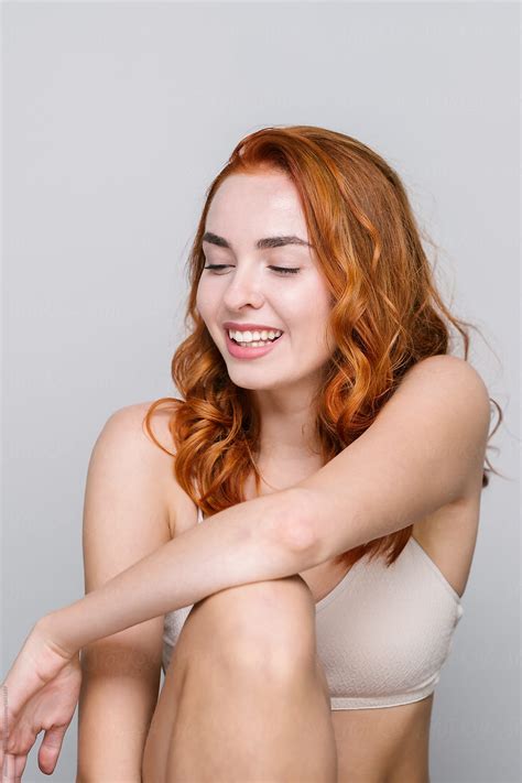 Studio Portrait Of Beautiful Redhead Woman On Light Gray Background By Stocksy Contributor