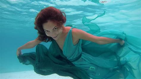 Underwater Young Beautiful Girl In Dress Posing Submerged Under Water