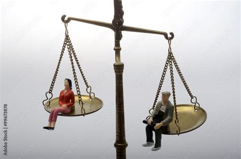 Man And Woman Sitting On Golden Weighing Scale Stock Photo Adobe Stock