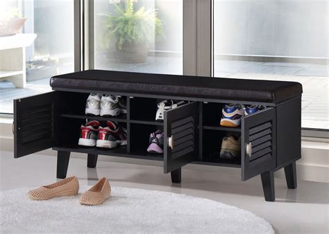 A Black Shoe Bench With Two Cubbys Underneath It