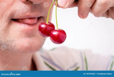 a man holds cherries in his hand and wants to eat it seductive cherries stock image image of