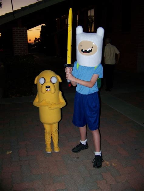 Two People In Costume Standing Next To Each Other