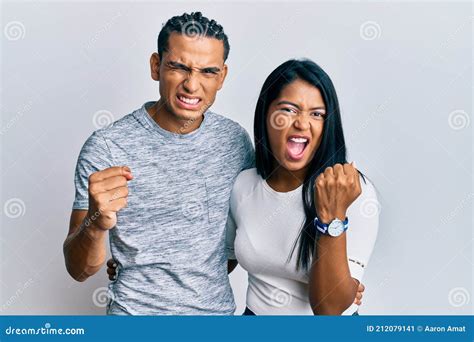 Young Latin Couple Wearing Casual Clothes Angry And Mad Raising Fist