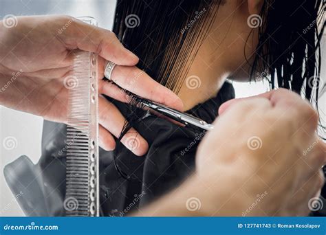 Hairdresser Cutting Client S Hair In Salon With Scissors Closeup Using