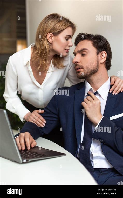 Passionate Couple Flirts In The Office Businessman Looks On Woman