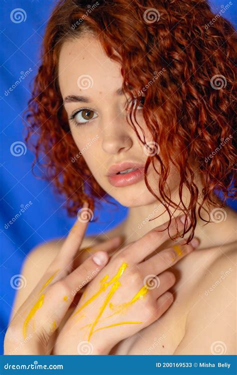 Redhead Curly Woman Hands In Yellow Paint Looks At The Camera Stock Image Image Of Isolated