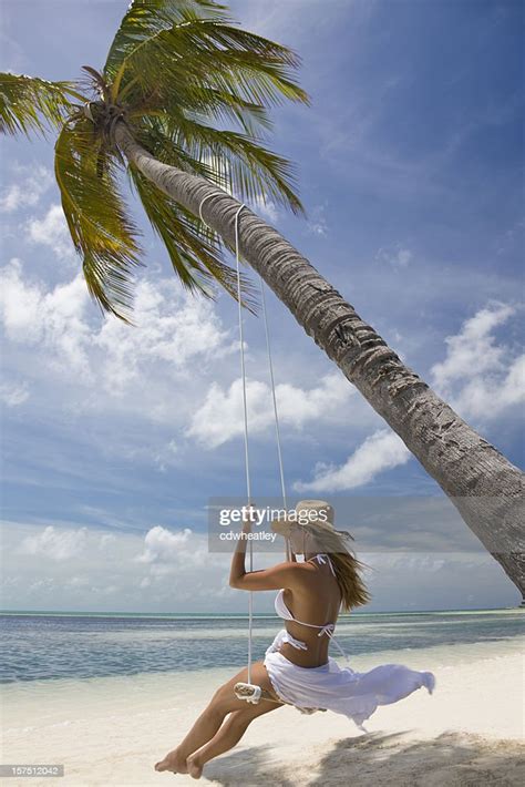 Woman Swinging At A Tropical Beach High Res Stock Photo Getty Images