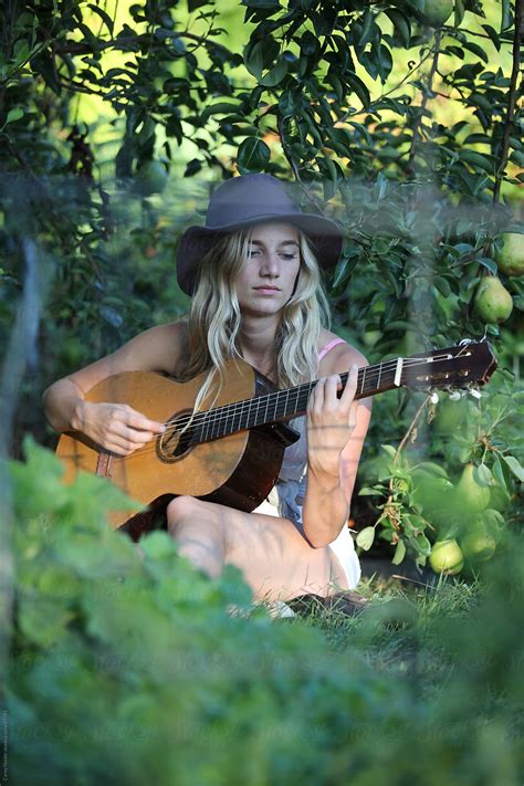 A Female Playing A Guitar By Stocksy Contributor Carey Haider Stocksy