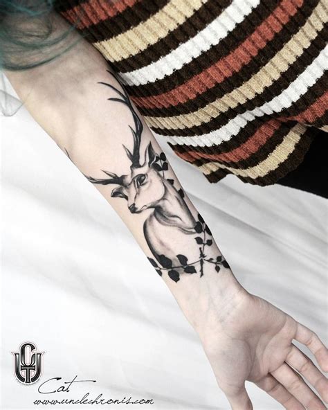 A Person With A Deer Tattoo On Their Arm