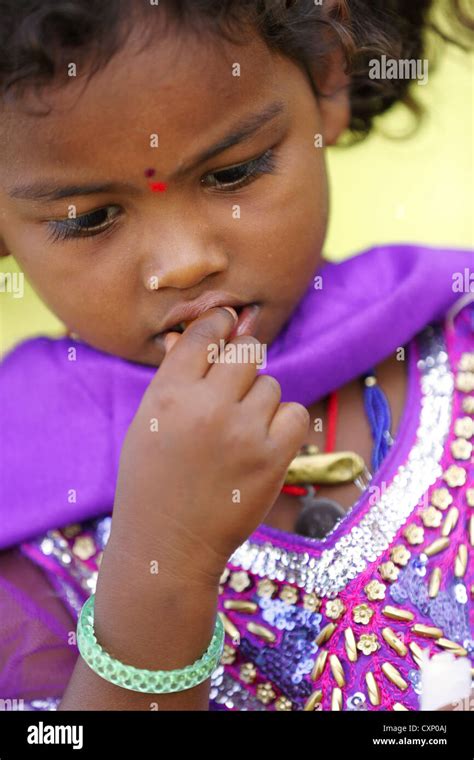 Indian Girl Eating A Caramel Sweet Andhra Pradesh South India Stock