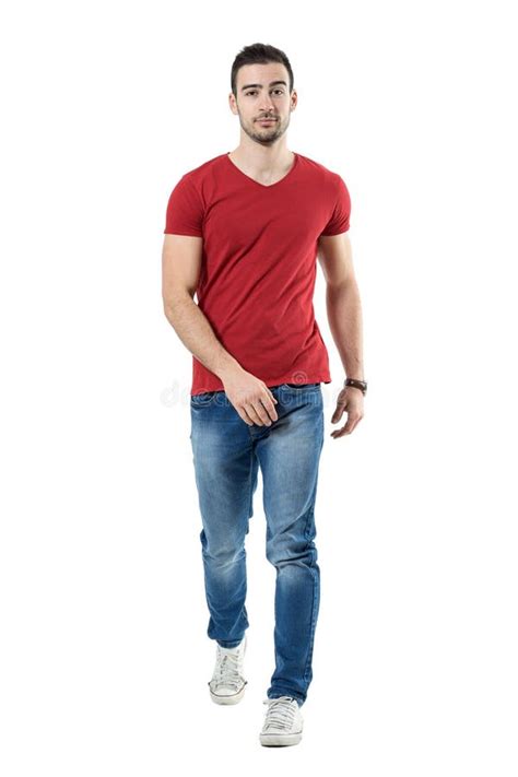 Relaxed Casual Man In Jeans And Red T Shirt Walking And Looking At