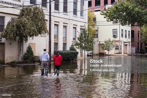 Hurrican Sandy People Walking On A Flooded Street Stock Photo