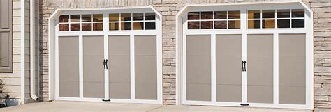 Two Garage Doors Are Open In Front Of A Brick Building