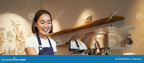 Portrait Of Cute Barista Girl Working Behind Counter Making Coffee