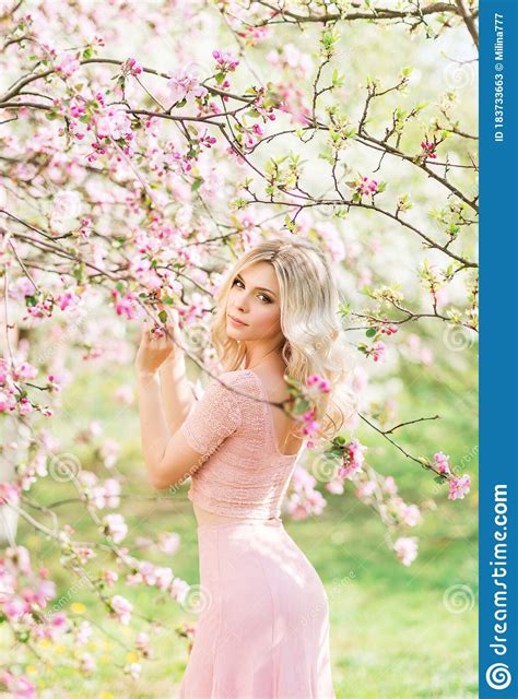 Beautiful Blonde Woman In Pink Flowers Spring Garden In The Sun Stock Image Image Of Blossom