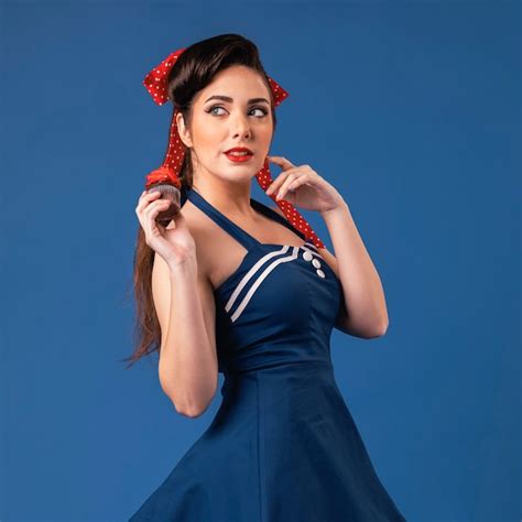 Premium Photo Beautiful Pinup Girl Posing In A Blue Studio