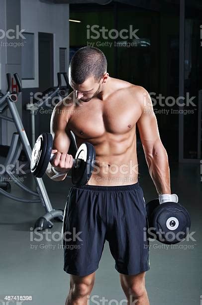Handsome Muscular Male Model With Perfect Body Doing Biceps Exercise