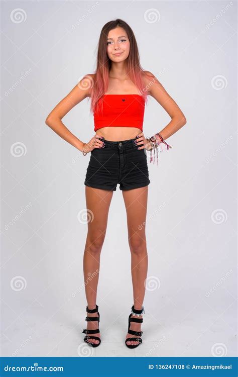 Full Body Shot Of Young Beautiful Rebellious Woman Standing Stock Photo