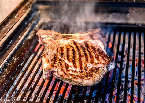 However the flavors will not penetrate as deeply compared with an overnight marinade for. Grilling Big T-bone Steak On Natural Charcoal Barbecue Grill. Stock Photo - Image of grilled ...