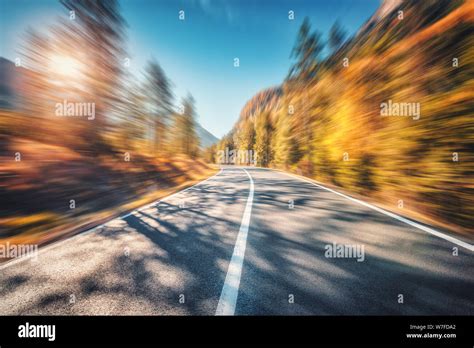 Mountain Road In Autumn Forest At Sunset With Motion Blur Effect Stock