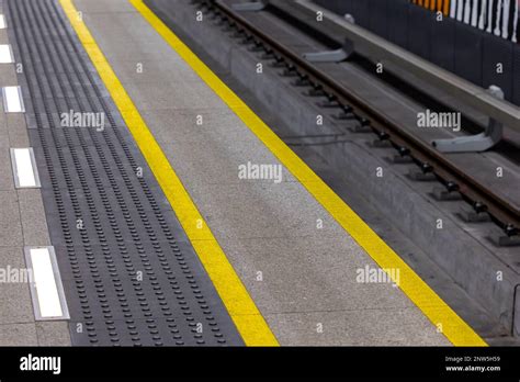 Yellow Warning Lines On A Subway Or Train Station Platform Safety