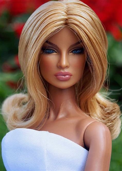 A Barbie Doll With Blonde Hair And Blue Eyes