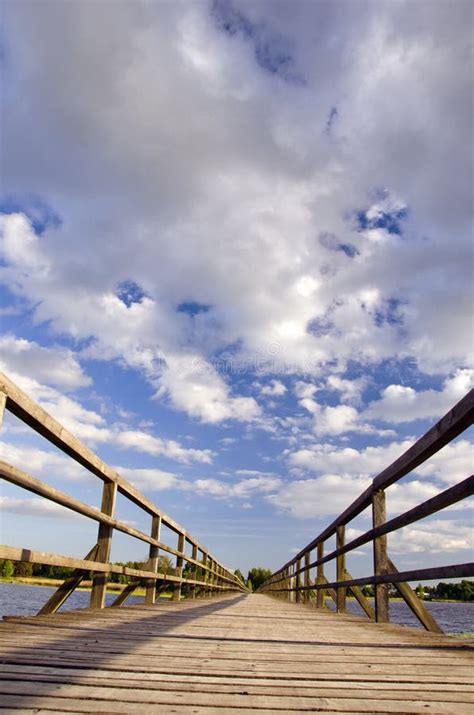 Long Wooden Plank Bridge Over Lake And Cloudy Sky Stock Photo Image