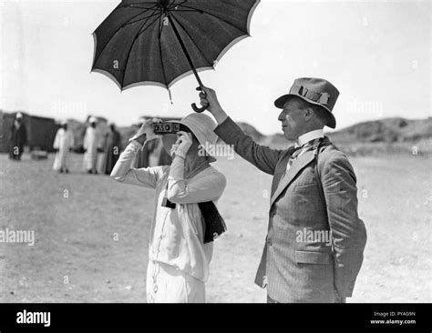 Taking Pictures In The 1930s A Woman Is Photographing Something With A Stereo Camera A Man Is