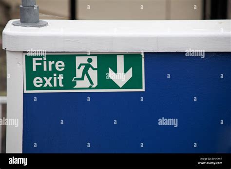 Fire Exit Sign On Blue Wall Of Public House Stock Photo Alamy