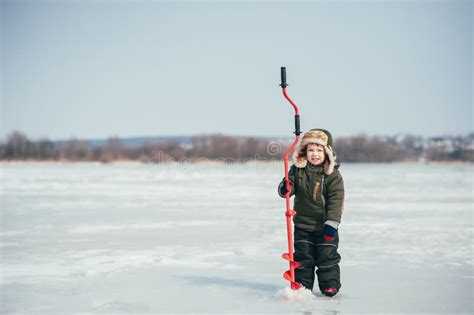 Boy Fishing On Winter Cute Boy Catches Fish In The Winter Lake Winter