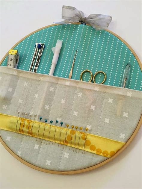 An Embroidery Project With Scissors Pins And Other Sewing Supplies On