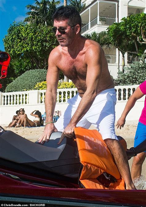 simon cowell 60 displays his newly taut physique as he takes to the waves on a jet ski in