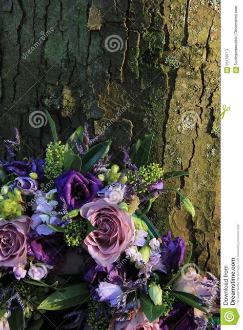 You can purchase online or come to our store to buy fresh cut flowers, plants, blooming plants, decorative trees, silk flowers, floral decor, vase flower arrangements, bulk flowers, flowers for weddings, funeral and sympathy flowers. Purple Sympathy Flowers Near A Tree Stock Image - Image of ...