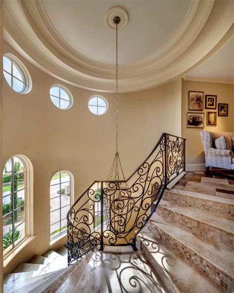 Spiral Staircase Showcasing Neutral Marble Tread And Small Tile Mosaic