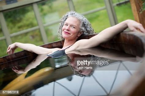 Portrait Of Mature Woman Relaxing In Hot Tub At Eco Retreat Stock Foto