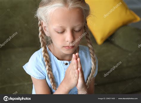 Little Girl Praying At Home Stock Photo By ©serezniy 294011400