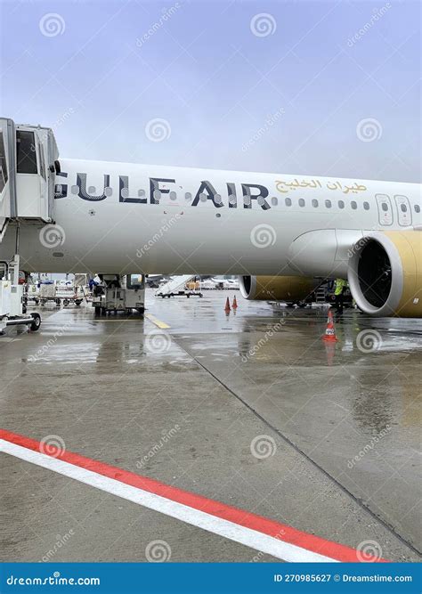 Gulf Air Bahrain Airplane Turbine Of Plane On Runway Airport Wet From Rain And Snow Takeoff