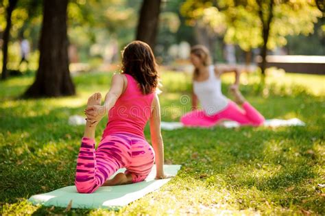 Group Of Women Doing Yoga Exercises On The Grass In A Park Legs Shot Stock Image Image Of