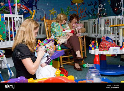 Daycare Workers Feeding Infants In Nursery Stock Photo 20125941 Alamy