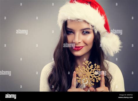 Christmas Woman In Santa Hat Smiling And Holding Winter Snowflake Fashion Model Girl With