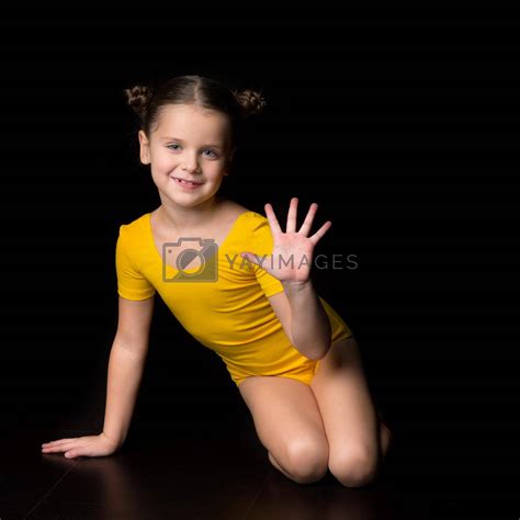 Cute Cheerful Little Girl Gymnast Sitting On Floor By Kolesnikovstudio