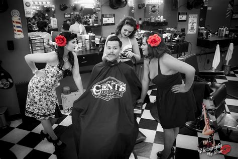 A Group Of Women Standing Around Each Other In A Barber Shop