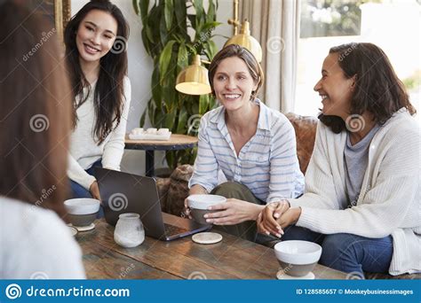Young Female Friends Talking Over Coffee At A Coffee Shop Stock Image