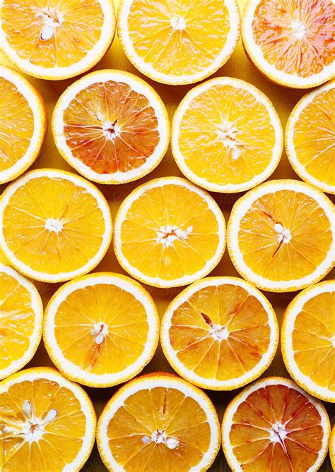Oranges On A Yellow Background Cut Oranges Background By Stocksy